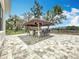 An outdoor tiki bar with seating for twelve, ideal for entertaining Gathering and friends at 464 Long & Winding Rd, Groveland, FL 34736