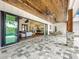 Outdoor patio area with a wood ceiling, open living space, and stylish furniture at 464 Long & Winding Rd, Groveland, FL 34736