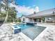 Outdoor pool and patio area with a fire pit, and spacious entertaining space at 464 Long & Winding Rd, Groveland, FL 34736