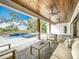 Inviting outdoor living space with a pool, spa, and stylish patio furniture at 464 Long & Winding Rd, Groveland, FL 34736