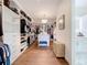Spacious walk-in closet with custom shelving, center island, and elegant lighting at 464 Long & Winding Rd, Groveland, FL 34736