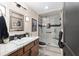 Well-appointed bathroom featuring a marble countertop vanity and a modern shower with a glass enclosure at 5510 Thome Loop, The Villages, FL 32163