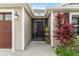 Welcoming front entry with a secure screen door, exterior lighting, and elegant landscaping at 5510 Thome Loop, The Villages, FL 32163