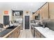 Modern kitchen featuring stainless appliances, marble countertops, and dark hardware at 5510 Thome Loop, The Villages, FL 32163