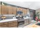 Modern kitchen featuring stainless steel appliances, light wood cabinets and marble countertops at 5510 Thome Loop, The Villages, FL 32163