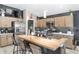 Bright kitchen with a butcher block island and barstools, stainless steel appliances, and sleek backsplash at 5510 Thome Loop, The Villages, FL 32163