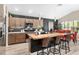 Modern kitchen featuring a butcher block island with bar seating, stainless appliances and stylish backsplash at 5510 Thome Loop, The Villages, FL 32163