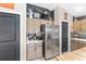 Kitchen featuring stainless steel appliances, dark accent wall, light cabinets, and butcher block countertops at 5510 Thome Loop, The Villages, FL 32163