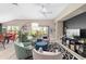 Bright living room with modern furnishings, a decorative rug, and sliding glass doors to outdoor space at 5510 Thome Loop, The Villages, FL 32163