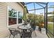 Outdoor dining area with grill on a covered patio at 5510 Thome Loop, The Villages, FL 32163