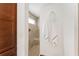 Bathroom featuring a tiled walk-in shower with a small window, alongside decorative wall hangings and plush towels at 5675 Herman Ave, The Villages, FL 32163