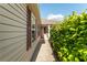 Charming front entrance with mature landscaping and covered porch at 5675 Herman Ave, The Villages, FL 32163