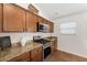 Well-equipped kitchen featuring wood cabinetry and stainless steel appliances at 5675 Herman Ave, The Villages, FL 32163