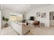 Bright living room featuring a comfy sofa, stylish decor, a large TV, and a large window at 5675 Herman Ave, The Villages, FL 32163