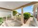 Inviting covered front porch with classic columns and meticulous landscaping at 5675 Herman Ave, The Villages, FL 32163