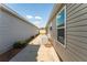 View of the side yard highlighting the walkway and exterior of home at 5675 Herman Ave, The Villages, FL 32163