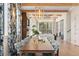 Open-concept dining room with hardwood floors, chandelier, and large windows providing natural light at 60 N Park Ave, Winter Garden, FL 34787