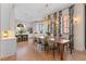 Bright dining room featuring stylish chairs, chandelier, and large windows with decorative curtains at 60 N Park Ave, Winter Garden, FL 34787