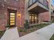 Exterior of townhome with brick and siding, large windows, and manicured landscaping at 60 N Park Ave, Winter Garden, FL 34787