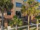 Exterior of a townhome with a small balcony and view of the grounds and landscaping at 60 N Park Ave, Winter Garden, FL 34787