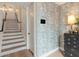 Foyer with decorative staircase, wallpaper, wood flooring, and decorative chest at 60 N Park Ave, Winter Garden, FL 34787