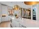 Modern kitchen featuring a large island, white cabinets, and a view into the dining room at 60 N Park Ave, Winter Garden, FL 34787