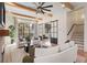 Bright living room with beamed ceiling, modern furniture, and large windows at 60 N Park Ave, Winter Garden, FL 34787