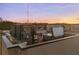 Aerial view of rooftop terrace at dusk with jacuzzi, dining, and outdoor grill at 60 N Park Ave, Winter Garden, FL 34787