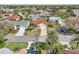 Neighborhood aerial view of home with red roof, highlighting its manicured landscaping and serene surroundings at 750 Evelynton Loop, The Villages, FL 32162