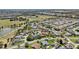 An aerial shot showcasing a community featuring single-Gathering homes nestled next to a serene pond and a manicured golf course at 750 Evelynton Loop, The Villages, FL 32162