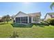 Spacious backyard featuring a screened-in lanai, offering a perfect blend of indoor-outdoor living at 750 Evelynton Loop, The Villages, FL 32162