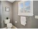 Bathroom featuring toilet, towel rack and shuttered window at 750 Evelynton Loop, The Villages, FL 32162