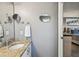 Bathroom sink with granite countertop and view into the bedroom at 750 Evelynton Loop, The Villages, FL 32162