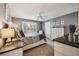 Well-lit bedroom with shutters, ceiling fan, neutral tones, and coordinated furniture at 750 Evelynton Loop, The Villages, FL 32162