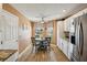 Charming breakfast nook with a round table, wood floors, and natural light from the windows at 750 Evelynton Loop, The Villages, FL 32162