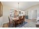 Well-lit dining area featuring hardwood floors and views into the kitchen at 750 Evelynton Loop, The Villages, FL 32162