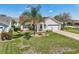 Inviting single-Gathering home boasts a manicured lawn and paver driveway at 750 Evelynton Loop, The Villages, FL 32162