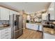 Modern kitchen featuring stainless steel appliances, tile backsplash, and an open layout at 750 Evelynton Loop, The Villages, FL 32162