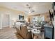 Inviting living room featuring a sliding glass door to the Florida Room and vaulted ceiling at 750 Evelynton Loop, The Villages, FL 32162