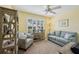 Living room with neutral walls, a ceiling fan, and a shuttered window at 750 Evelynton Loop, The Villages, FL 32162