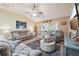 Comfortable living room with vaulted ceiling and a sliding glass door to the Florida Room at 750 Evelynton Loop, The Villages, FL 32162