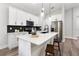 Bright kitchen features white cabinets, stainless steel appliances, and a large island with barstool seating at 7505 Sw 137Th Court Rd, Dunnellon, FL 34432