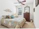 Relaxing bedroom with a ceiling fan, a decorative headboard, and soft natural light, creating a calm space at 8051 Saint James Way, Mount Dora, FL 32757