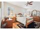 Charming bedroom featuring wood furniture, a ceiling fan, plantation shutters, and a cozy, decorative rug at 8051 Saint James Way, Mount Dora, FL 32757