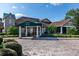 Beautiful clubhouse exterior with elegant entrance and manicured landscaping at 8051 Saint James Way, Mount Dora, FL 32757