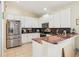 Modern kitchen with white cabinets, stainless steel appliances, and granite countertops at 8051 Saint James Way, Mount Dora, FL 32757