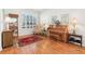 Sunlit room featuring piano, hardwood floors, and large windows with plantation shutters at 8051 Saint James Way, Mount Dora, FL 32757