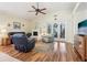 Inviting living room with a ceiling fan, fireplace, plush seating, and sliding glass doors leading to the outdoors at 8051 Saint James Way, Mount Dora, FL 32757