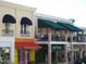 Charming street view featuring shops with awnings and balconies in a vibrant downtown area at 8051 Saint James Way, Mount Dora, FL 32757