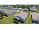 Aerial view of this home with lush landscaping, neat lawn, and enclosed sunroom at 841 Eagles Lndg, Leesburg, FL 34748